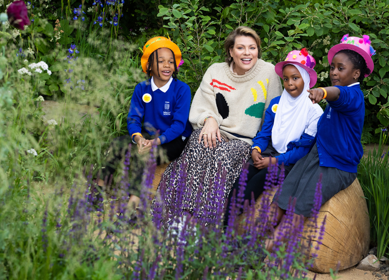 Pupils speak to Kate Silverton in the garden