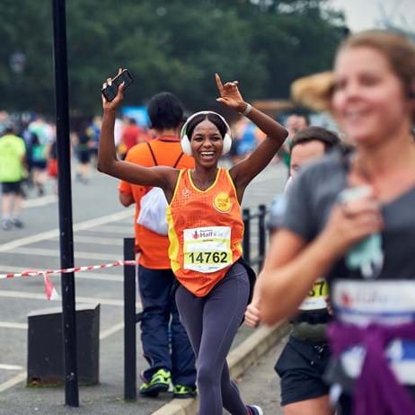 Place2Be Runner with arms in air