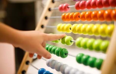 child playing with abacus