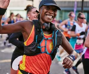 lady in Place2Be running vest running a marathon to fundraise for Place2Be