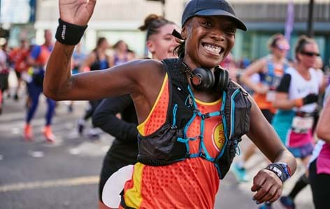 lady in Place2Be running vest running a marathon to fundraise for Place2Be