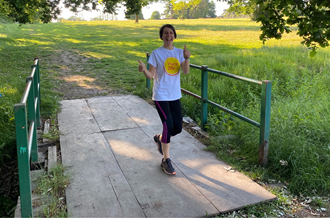 Person running over a bridge