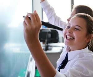 Girl writing on school whiteboard