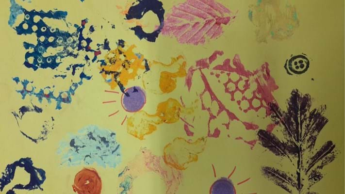 yellow paper with colourful paint leaf print design